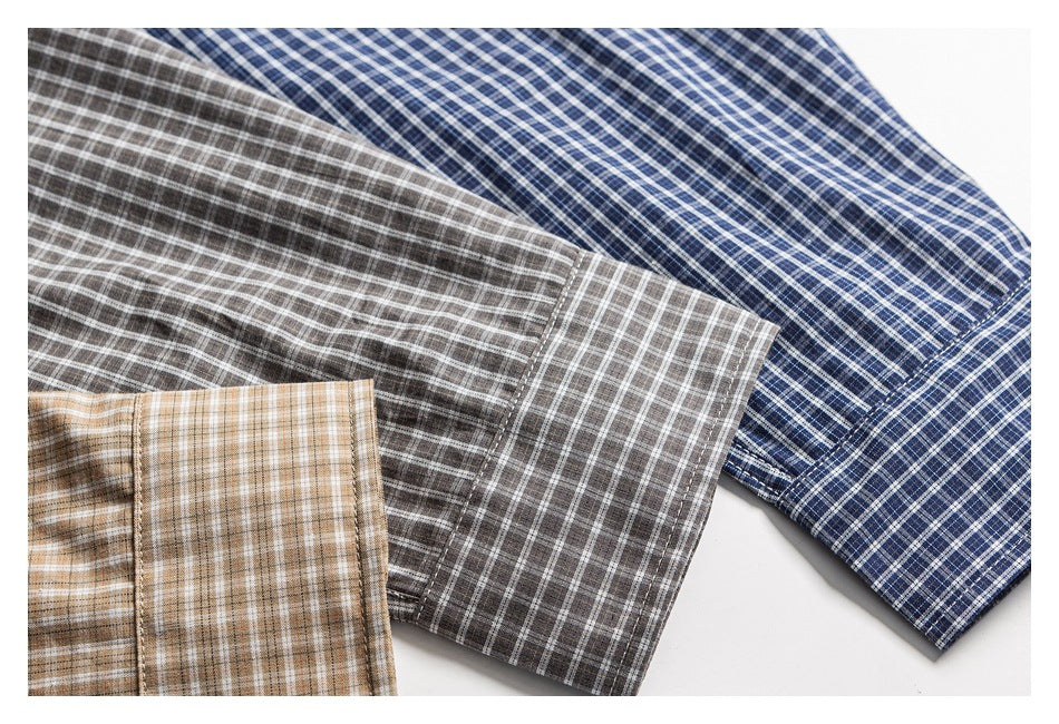 Three plaid shirt sleeves in blue, gray, and tan arranged together.