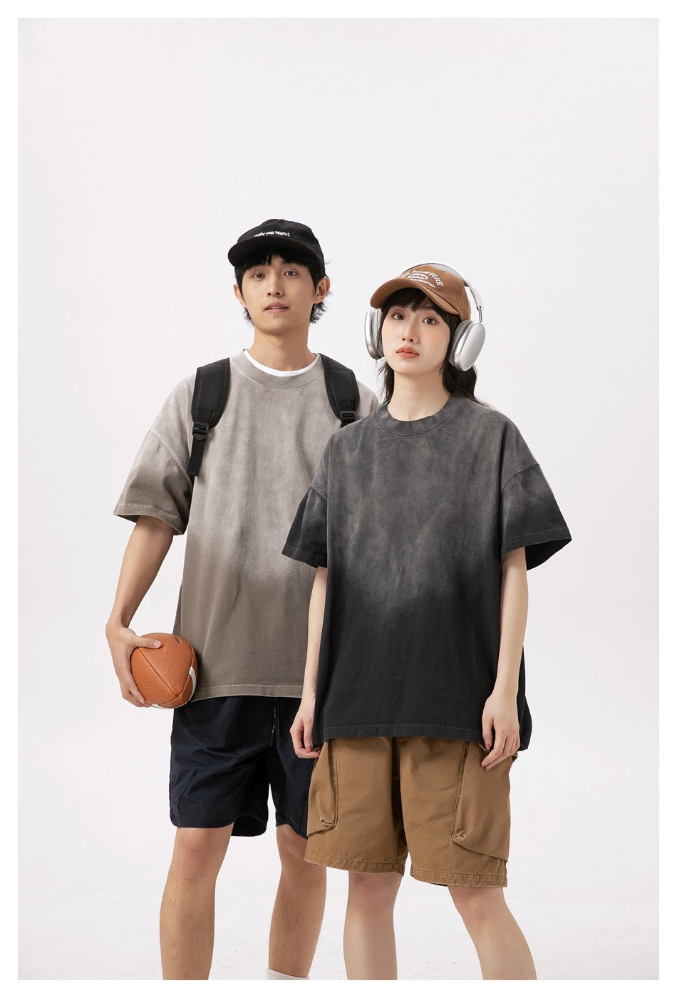 Two models wear oversized T-shirts in taupe-gray and charcoal, shown from the front.