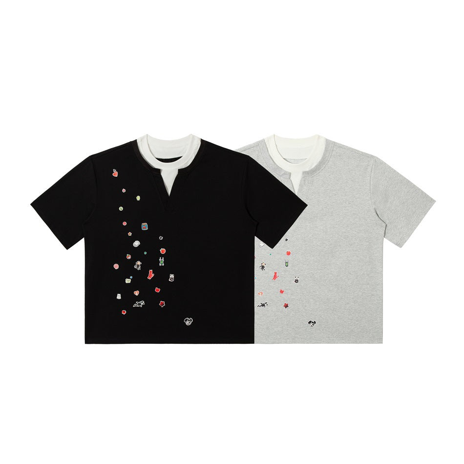 Black and gray short-sleeve T-shirts side by side, each with white layered collar and scattered cartoon graphics