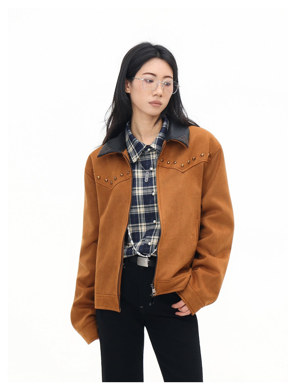 Model wearing the brown studded zip jacket open over a plaid shirt and black pants, close three-quarter view