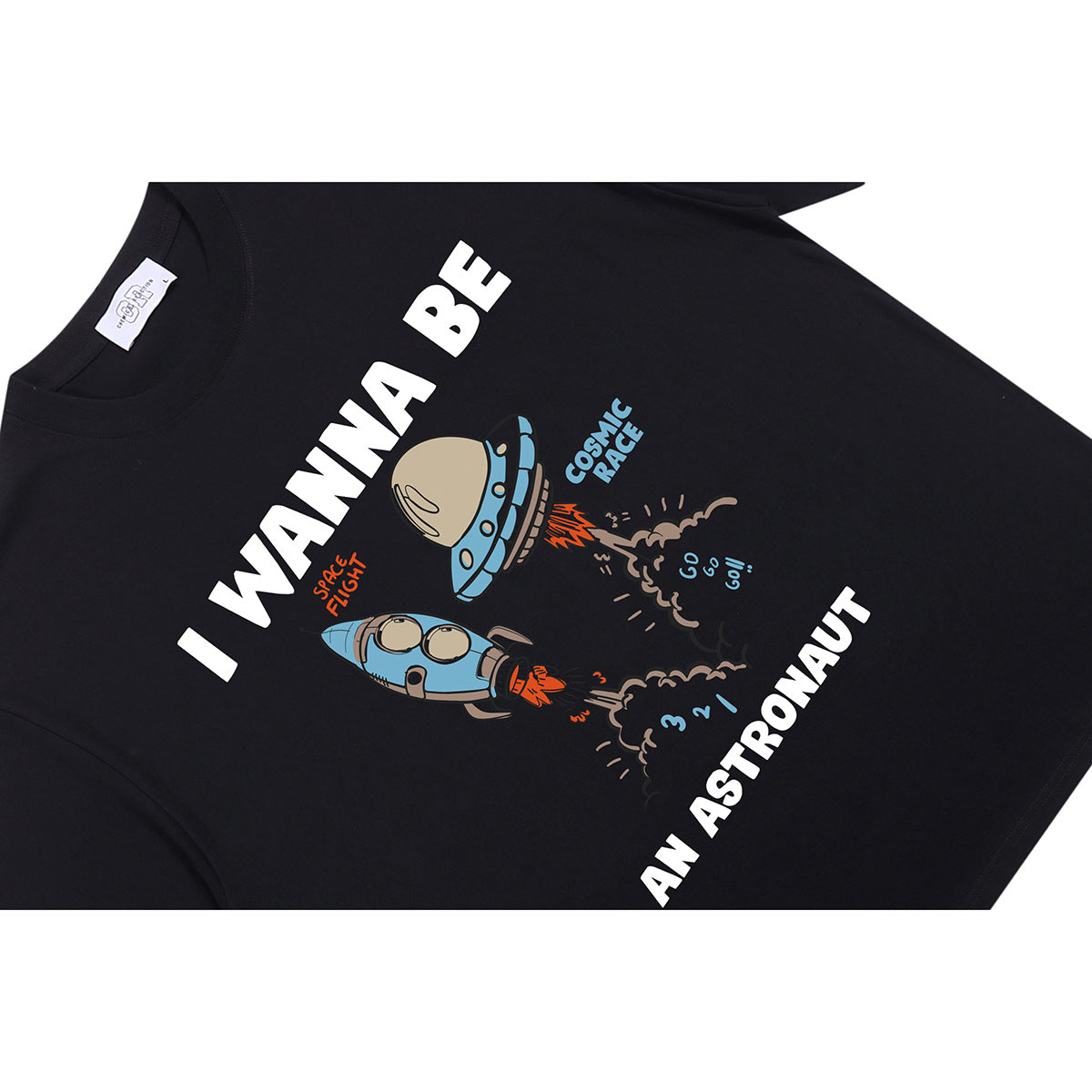 Close-up of a black T-shirt with a colorful rocket graphic and the words “I WANNA BE AN ASTRONAUT.”