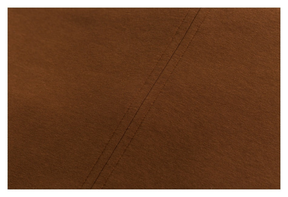 Close-up of brown fabric showing a diagonal stitched seam.