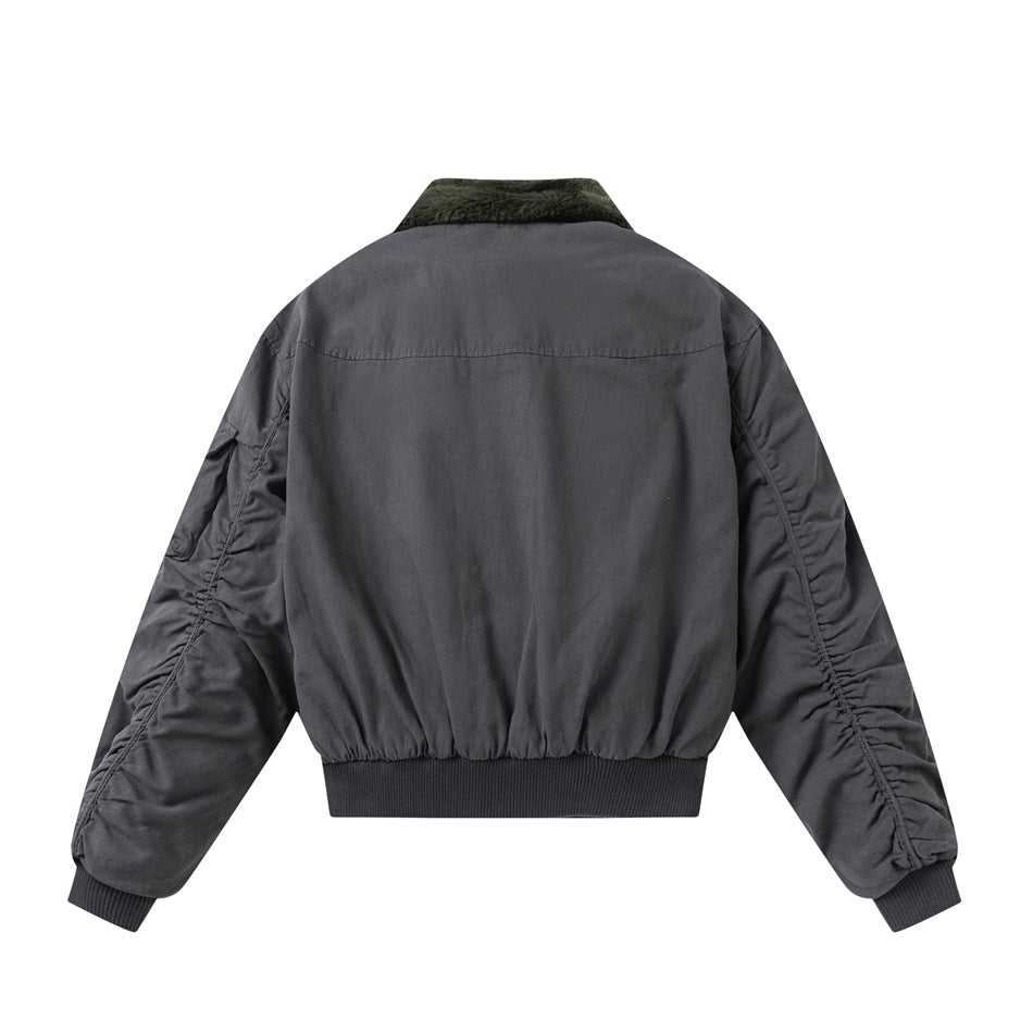 Back view of a charcoal gray bomber jacket with gathered sleeves and a dark ribbed hem.