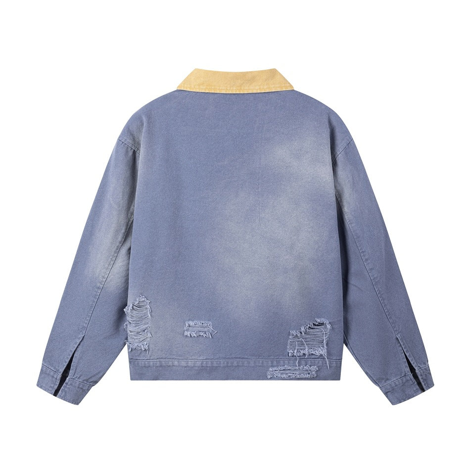 Back of a slate-blue jacket with a tan collar and several distressed patches near the hem, shown flat.