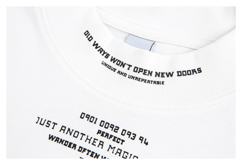 Close-up of a white T-shirt collar and chest with black English text printed on the fabric.