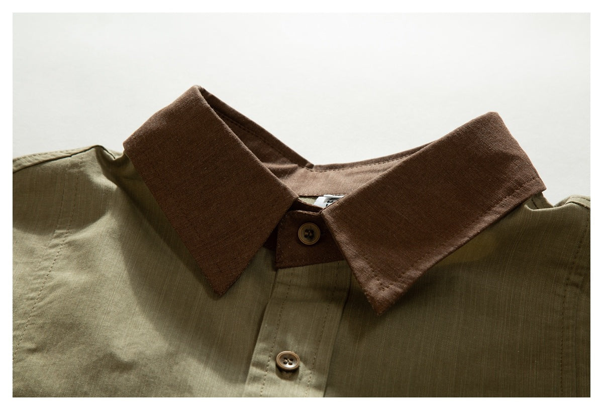 Close-up of an olive shirt with a contrasting brown pointed collar and brown buttons.