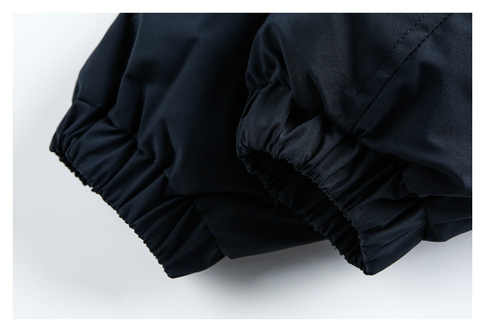 Close-up of the dark navy garment's gathered elastic cuffs.