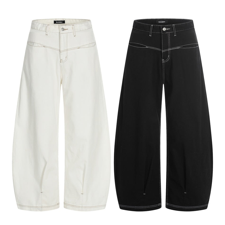 Front views of wide-leg trousers in cream and black, both with contrasting seam details.