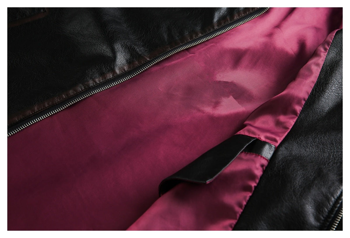 Open black jacket close-up showing burgundy lining, zipper, and an interior strap.