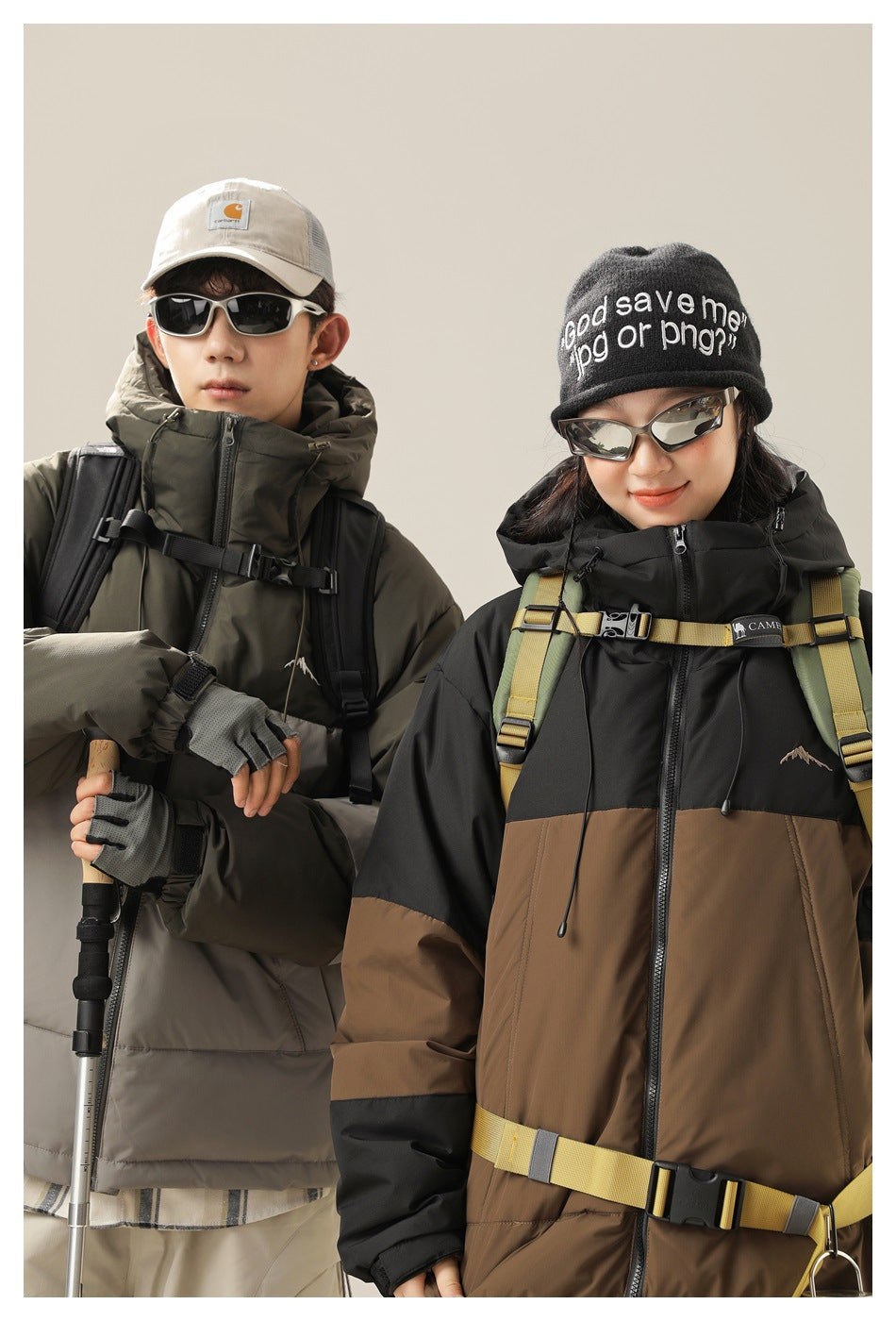 Close view of two models wearing hooded color-block puffer jackets in olive-gray and black-brown.