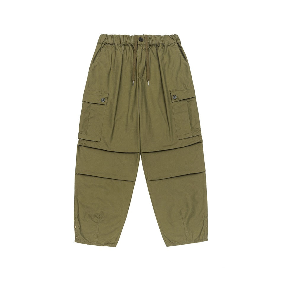 Olive green wide-leg cargo pants with elastic drawstring waist, flap cargo pockets and knee pleat seams, front view