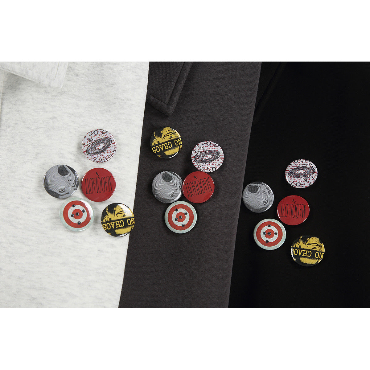 Three collared pullovers in light gray, charcoal, and black, each with colorful circular chest graphics.