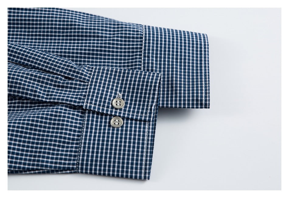 Close-up of a navy-and-white checked shirt cuff with two buttons.