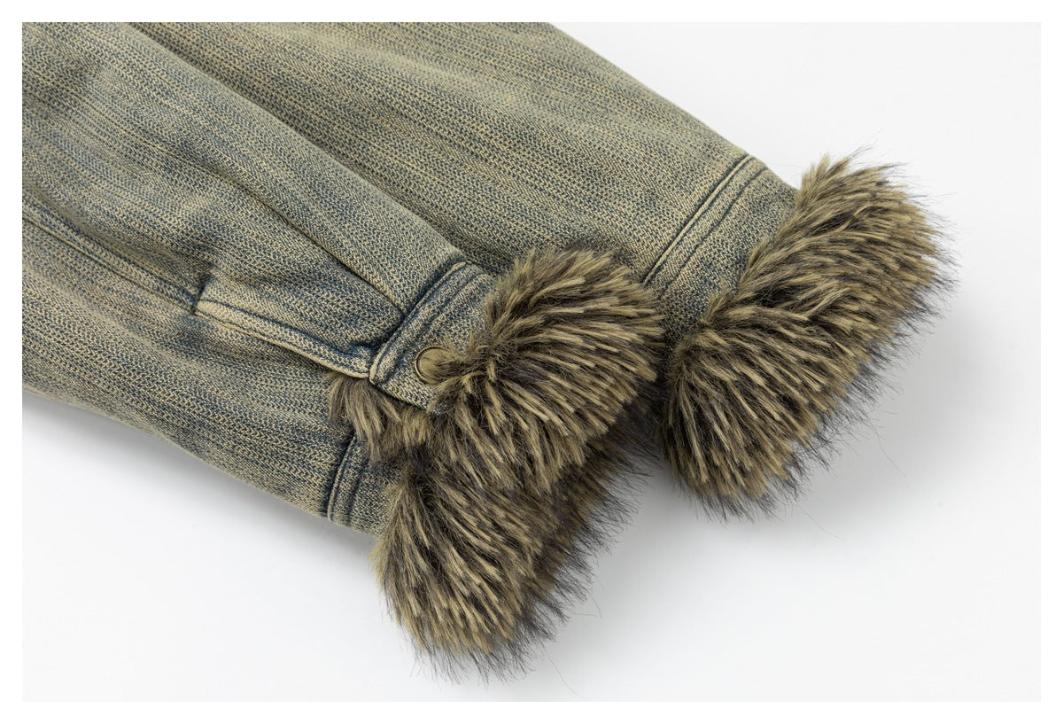 Close-up of a blue-gray jacket sleeve ending in a wide brown faux-fur cuff with a snap tab.