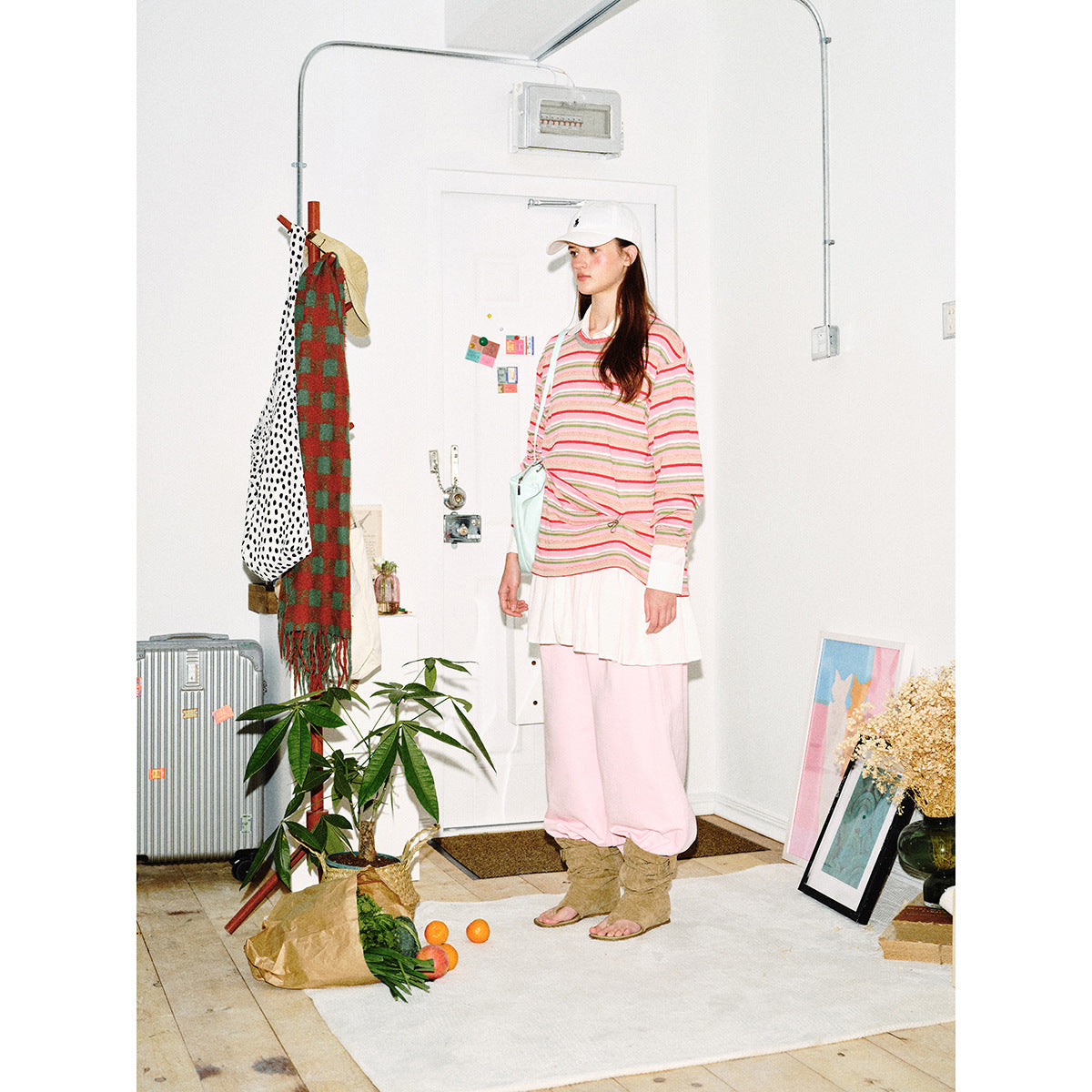 Full-length front view of a model wearing a pink multistripe long-sleeve top with a white collar and cuffs.