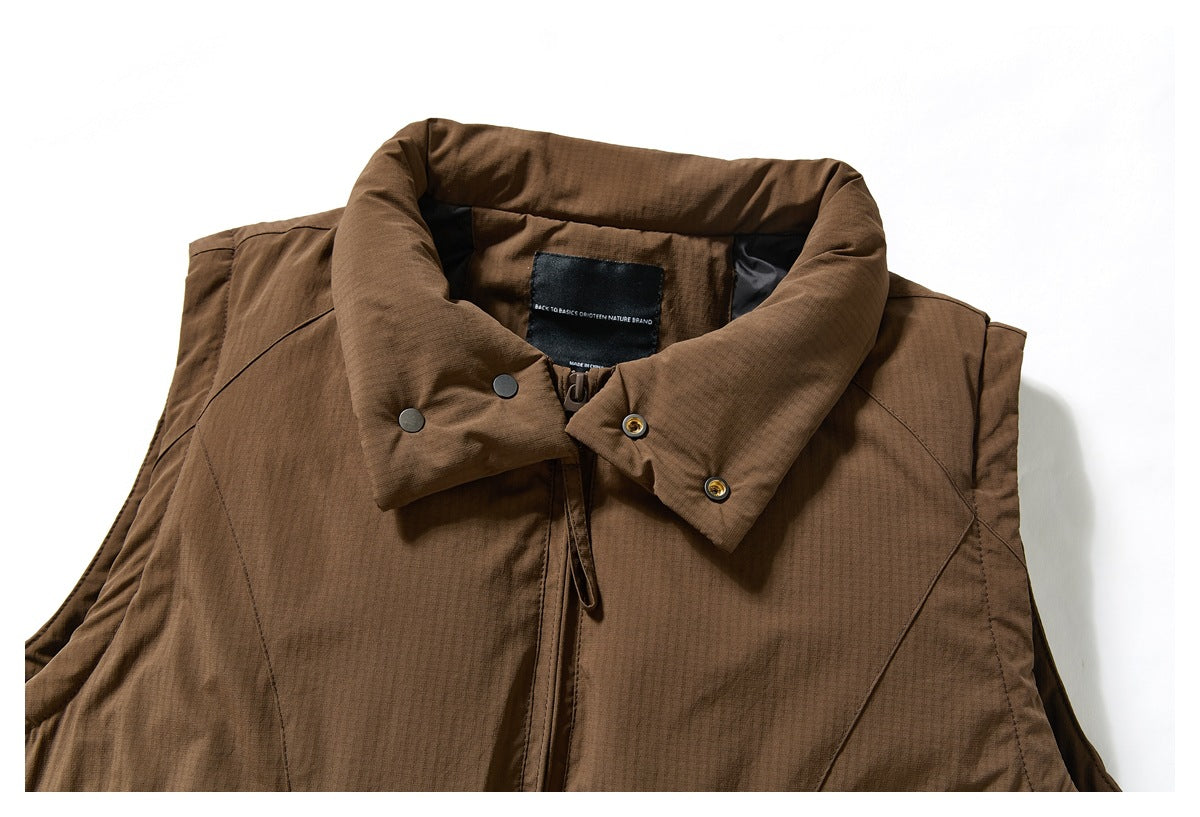 Close-up of the brown vest's high collar, snap fasteners, front zipper, and inner label.