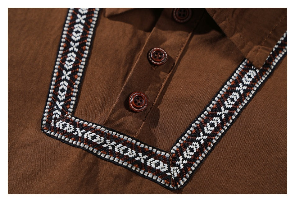 Close-up of the brown shirt's button placket and black, white, and brown geometric trim.