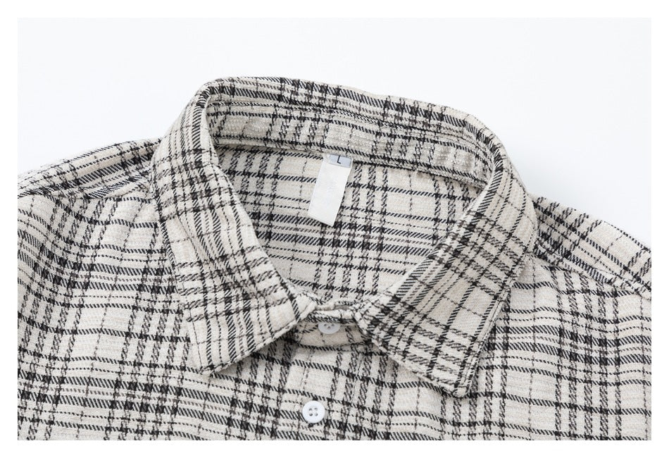 Close-up of the plaid shirt's collar, upper buttons, and inner size tag marked L.