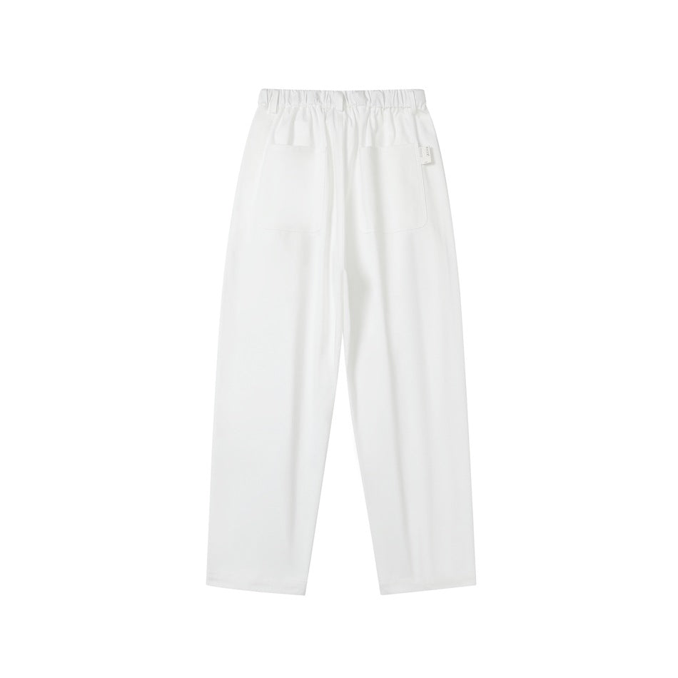 Rear view of white trousers with an elastic waistband and two patch pockets.