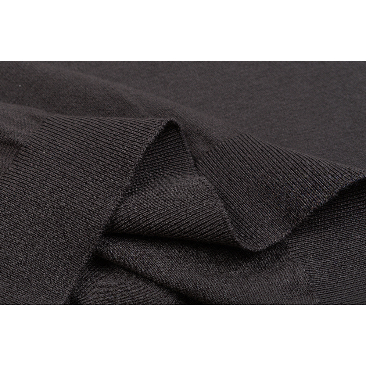 Close-up of taupe knit fabric with a folded ribbed edge and hem.