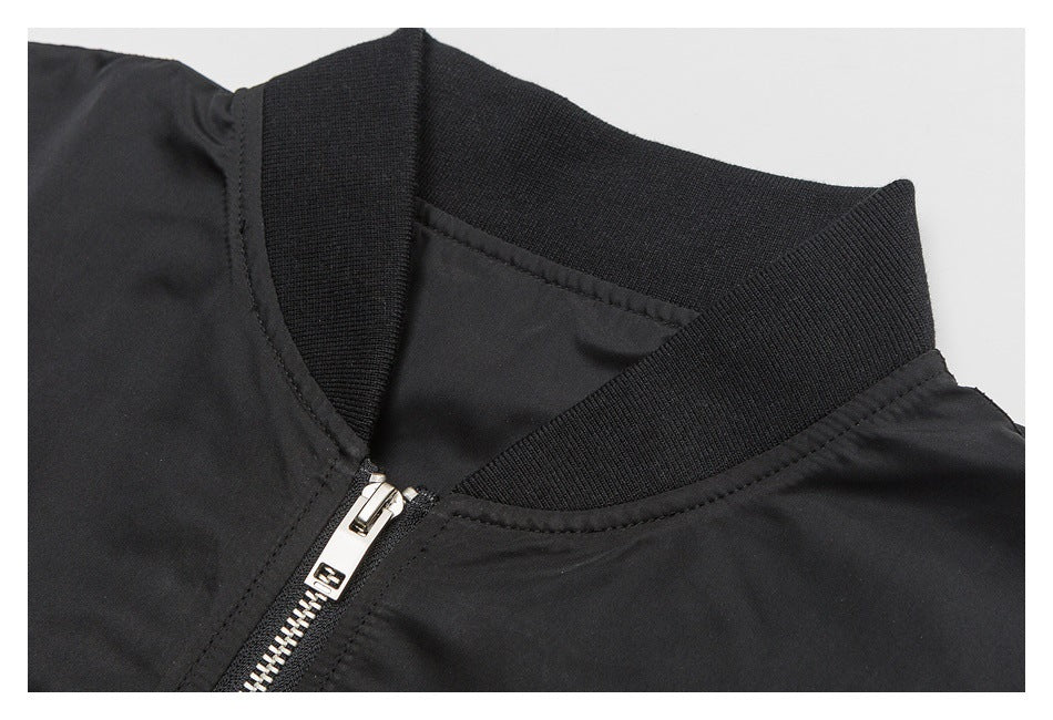 Close-up of the black jacket's ribbed collar and silver zipper.