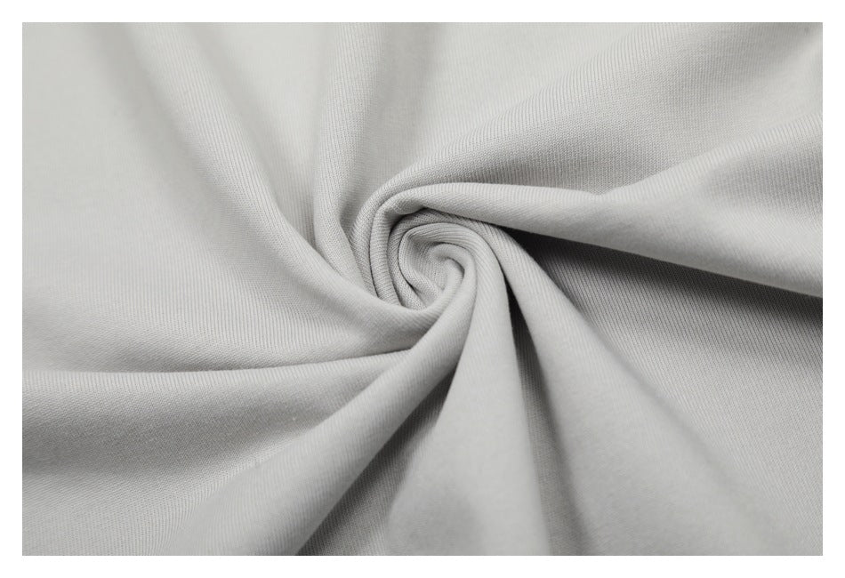Close-up of light gray fabric gathered into a spiral fold.