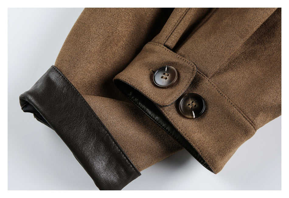Close-up of a brown jacket cuff with two dark buttons and a contrasting black inner edge.