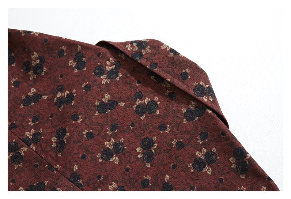 Close-up of the collar and upper panel of a reddish-brown floral shirt.