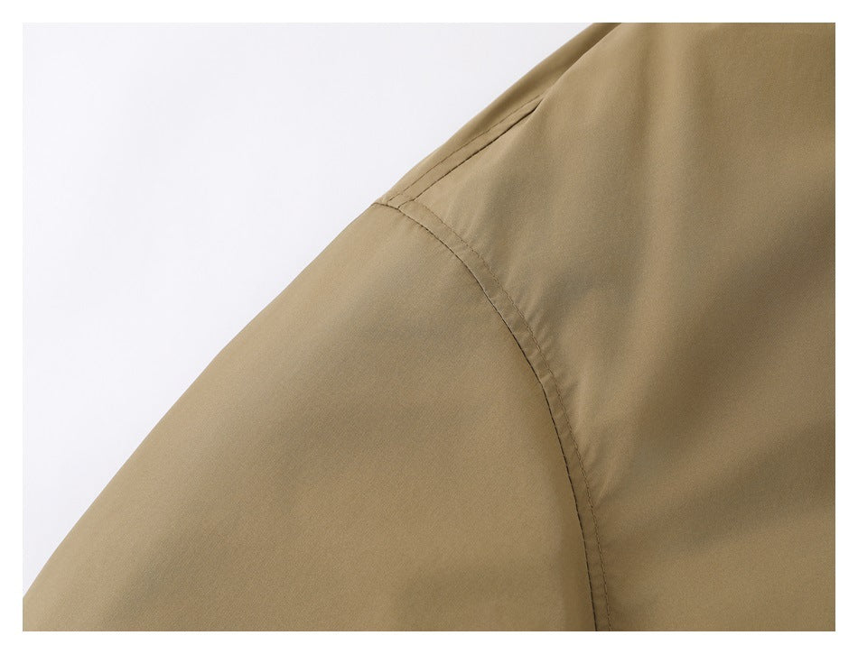 Close-up of the khaki jacket's shoulder seam and sleeve construction.