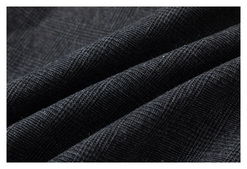 Close-up of dark charcoal fabric with a fine, tightly woven texture and soft folds.