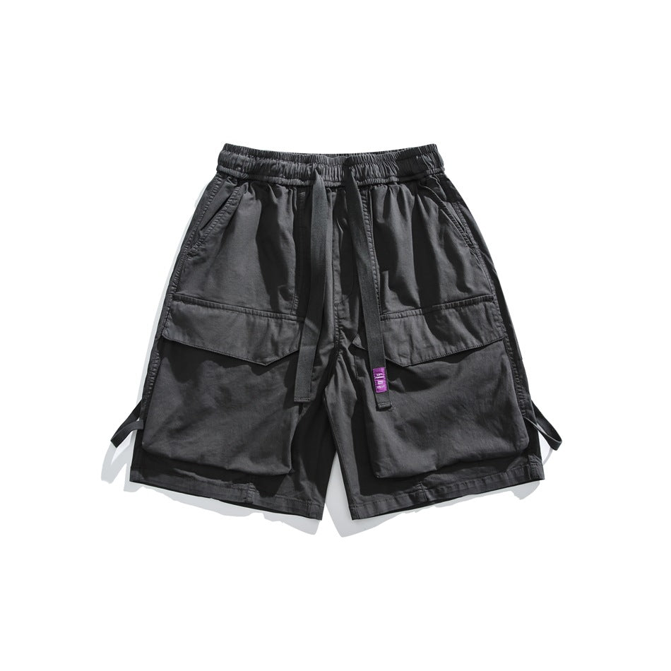 Dark gray cargo shorts with large flap pockets, elastic waistband and front strap with purple label