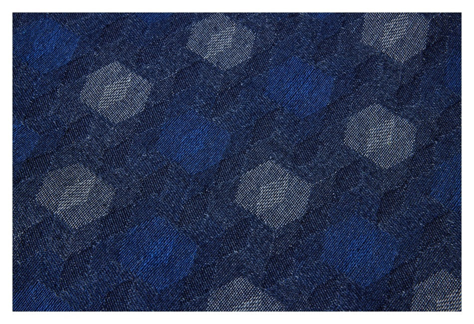 Close-up of the shirt's dark blue geometric woven pattern in blue and gray tones.