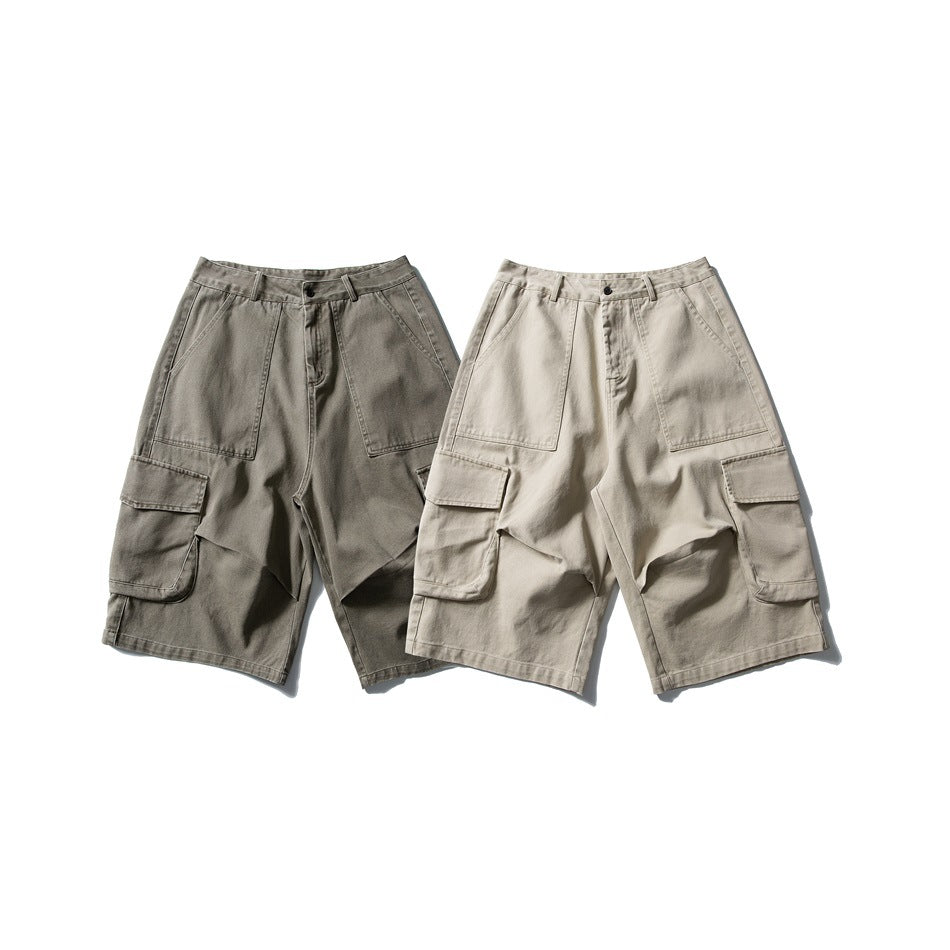 Two pairs of loose cargo shorts displayed together in dark gray-green and light khaki.