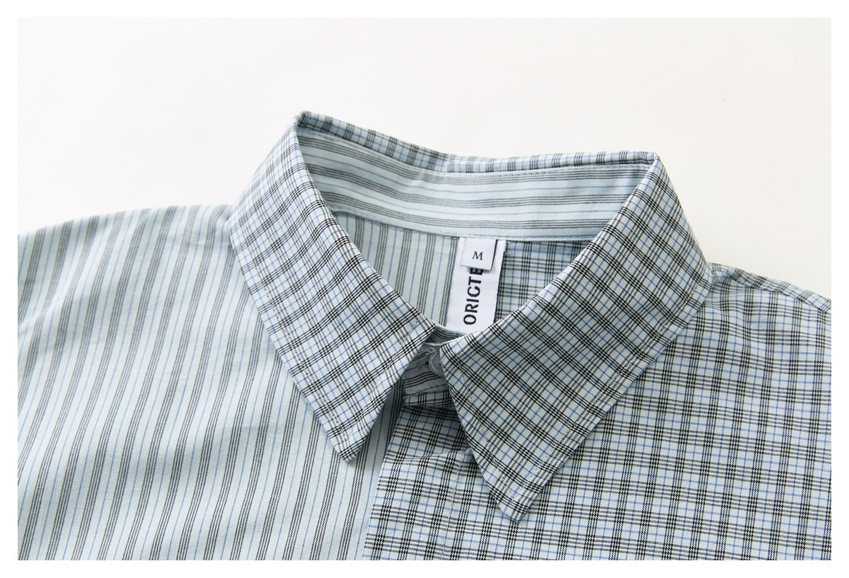 Close-up of a light blue and white striped shirt collar with a checked pattern and a visible neck label.