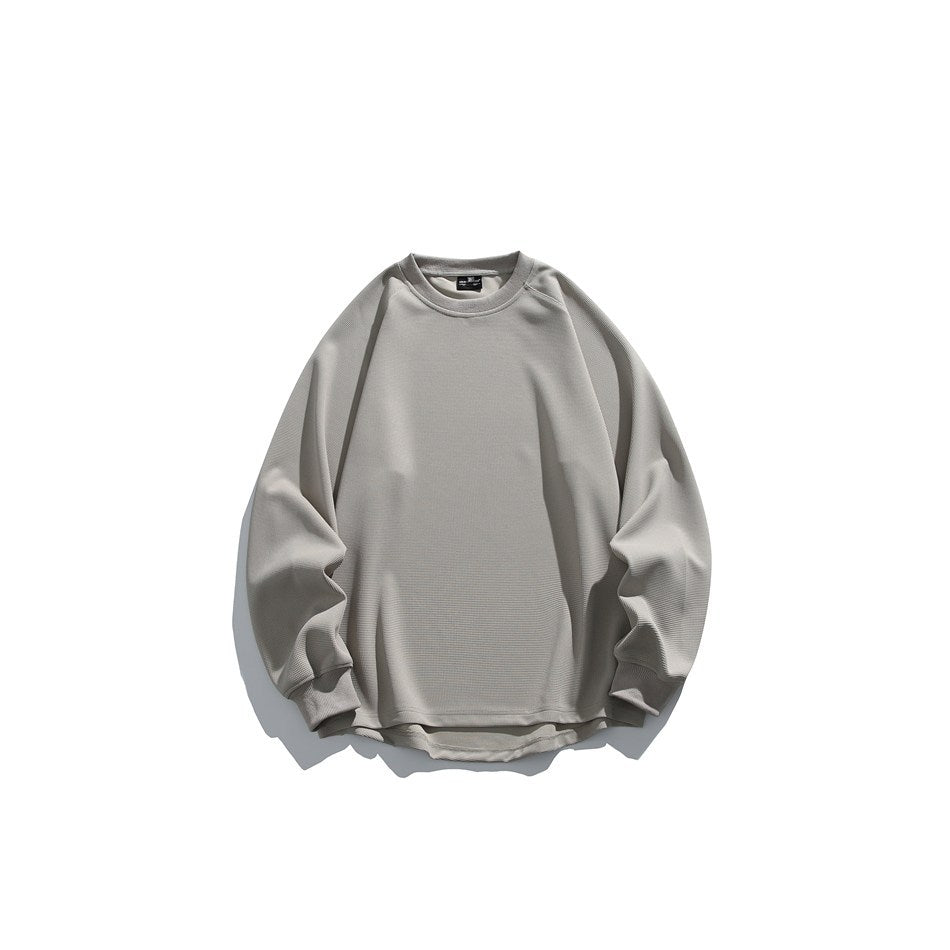 Beige-gray waffle-knit crew neck sweatshirt with raglan sleeves and curved hem, flat lay front view