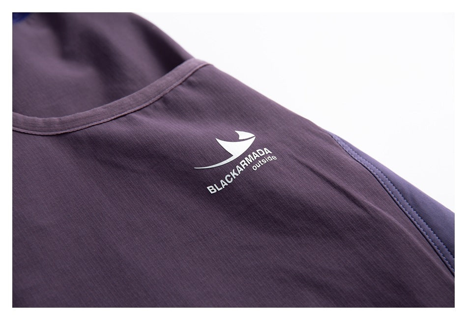 Close-up of a white sail graphic and BLACKARMADA outside lettering printed on purple pants.