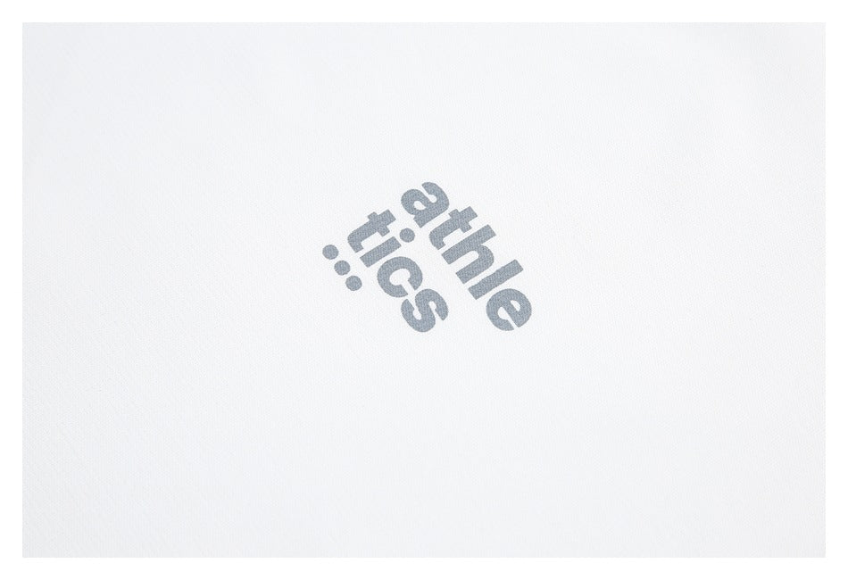 Close-up of a gray “athletics” print on white garment fabric.