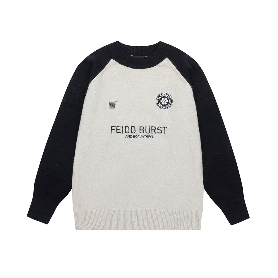 Light gray crewneck sweater with black raglan sleeves, ribbed trim and embroidered chest lettering and emblem, flat lay