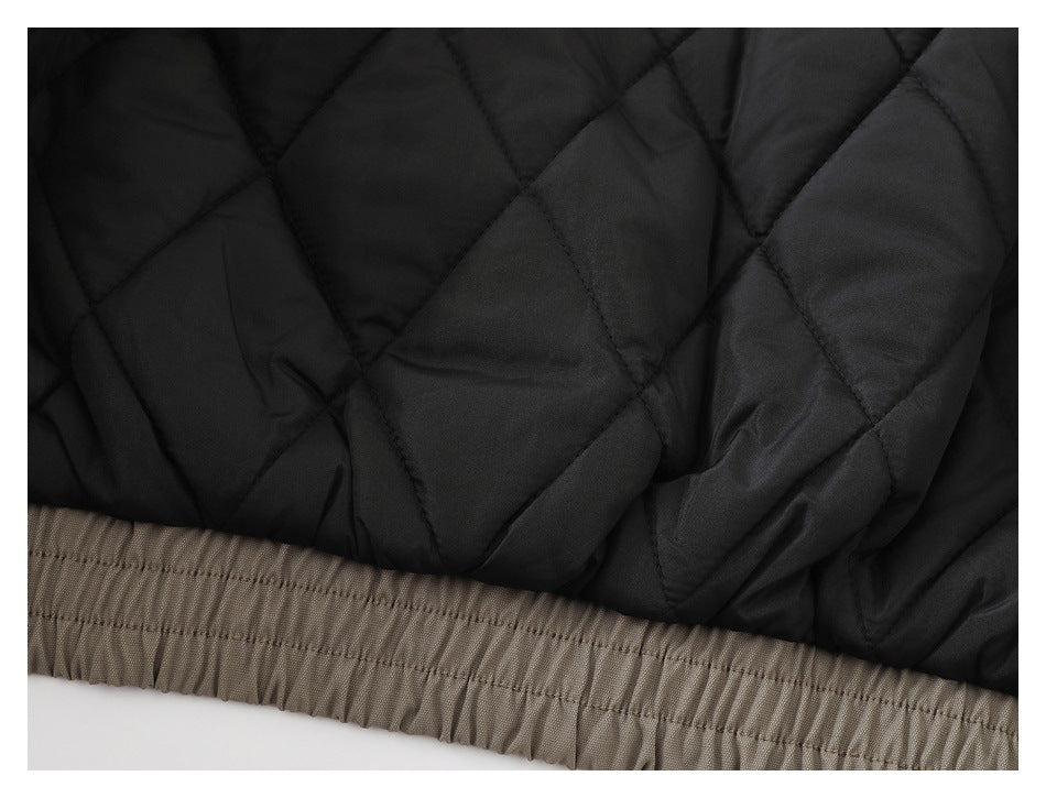 Close-up of black diamond quilting above a gathered taupe elastic hem.