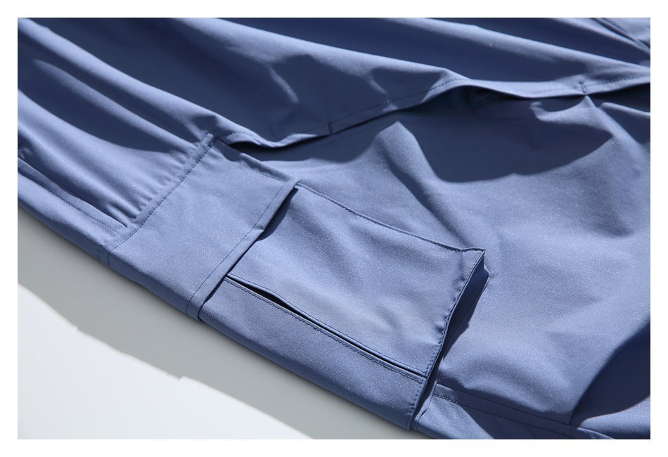 Close-up of a flap cargo pocket and stitching on slate blue pants.