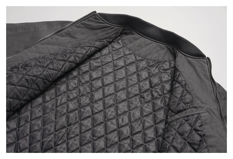 Open black jacket showing its diamond-quilted lining, inner pocket, and ribbed collar.