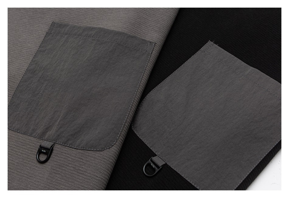 Close-up of large dark patch pockets with small loop hardware on charcoal-gray and black tops.