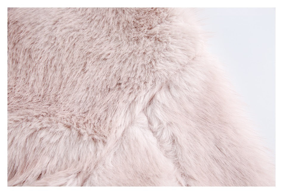Close-up of pale blush faux-fur jacket trim against a light background.