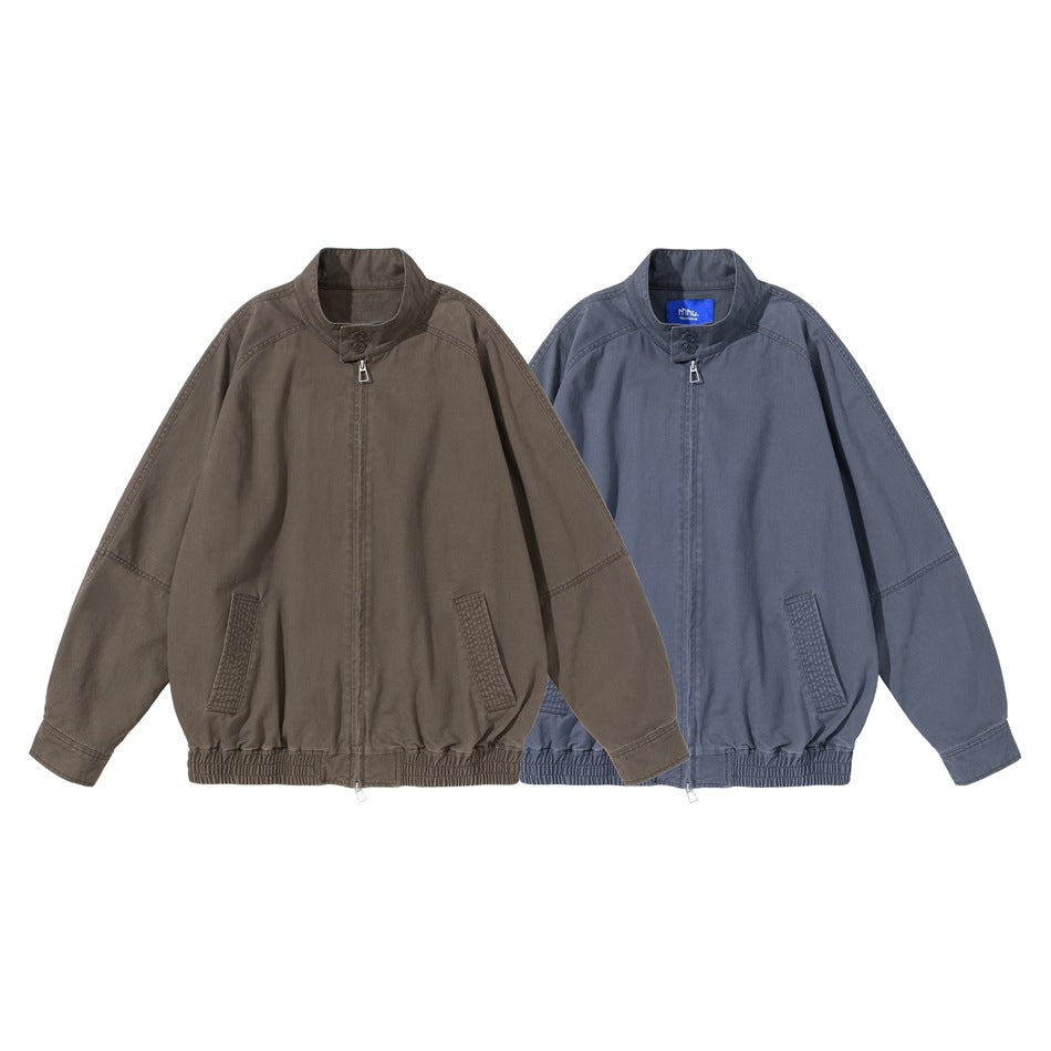 Front views of two zip-up jackets with stand collars and elastic hems, in brown-gray and dusty blue.
