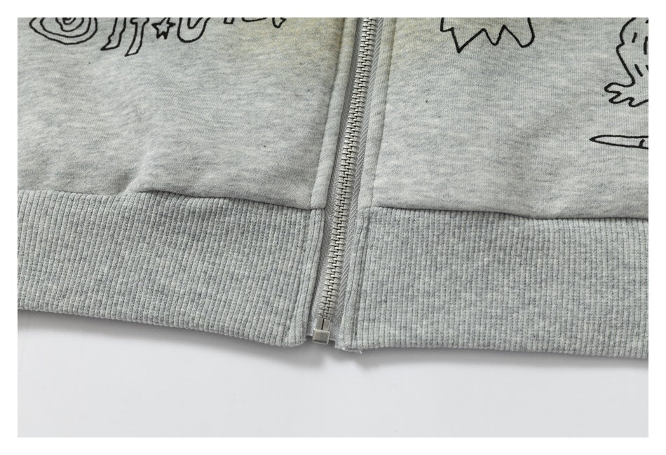 Close-up of the gray hoodie’s front zipper and ribbed hem.