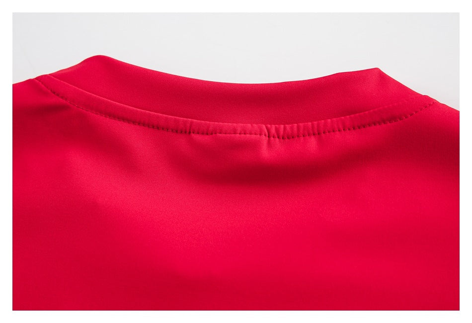 Close-up of the red garment's rounded neckline and stitched collar seam.