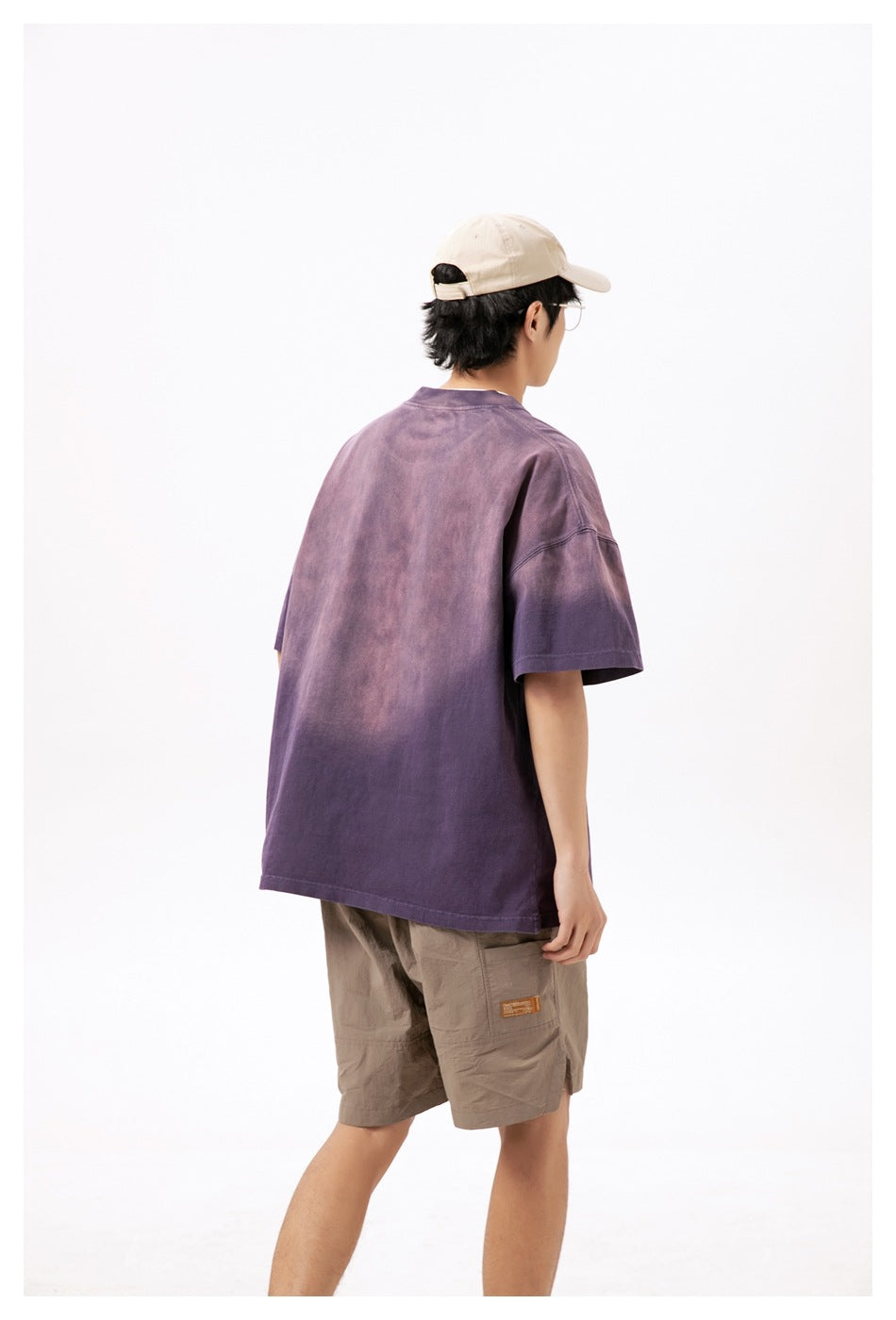 Model shown from behind wearing an oversized mottled purple short-sleeve T-shirt.