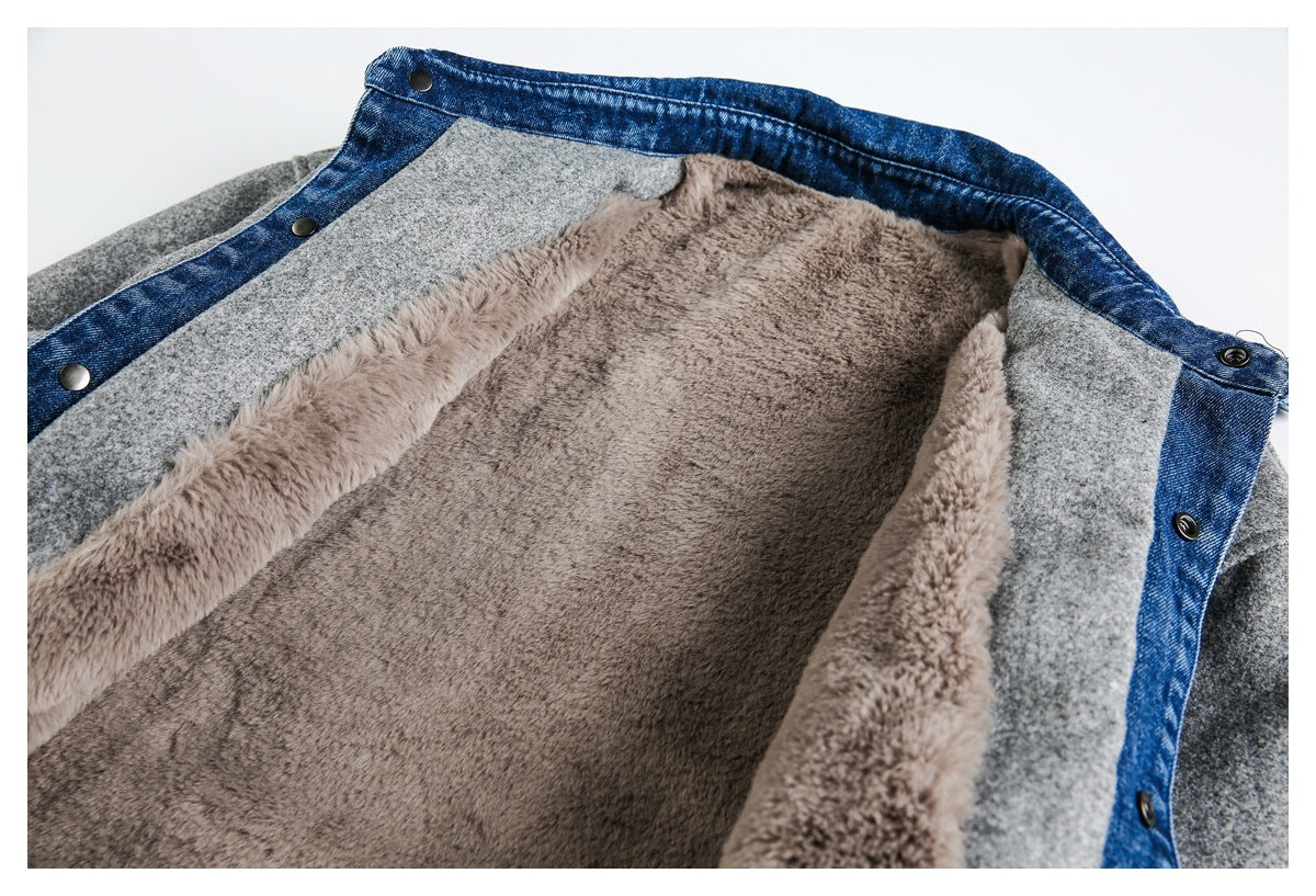 Close-up of a gray jacket opened to show plush taupe lining and blue denim trim with snap buttons.
