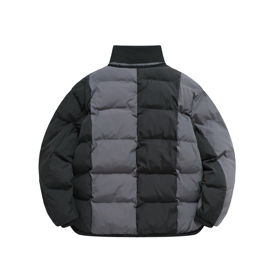 Back view of a charcoal gray and black quilted jacket with a tall black collar and ribbed cuffs.