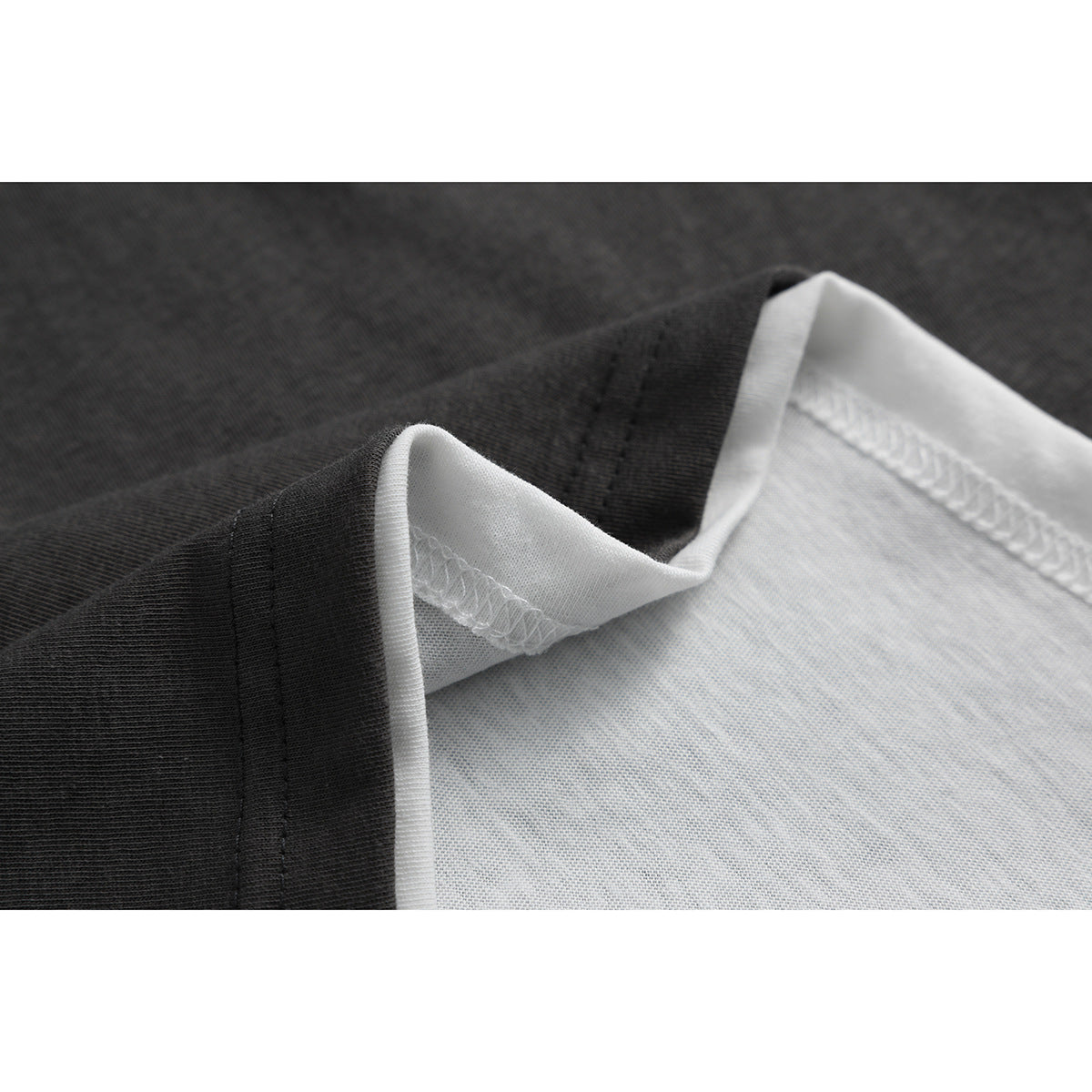 Close-up of the shirt's dark outer fabric and white inner fabric, showing the seam stitching.